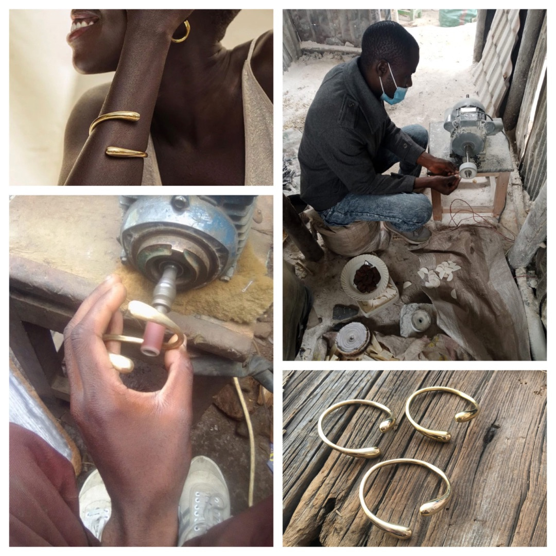 # Gold-Toned Metal Bracelets, Contemporary Artisan-Made

These are handcrafted metal bracelets made from gold-toned or brass-colored metal, featuring a modern minimalist design with open cuff construction and decorative ball or knob terminals at each end. The bracelets appear to be contemporary pieces created by an artisan metalworker, as evidenced by the workshop setting and manufacturing process shown. The set includes three similar bracelets in varying sizes, showcasing traditional metalworking techniques using hand tools and a lathe.