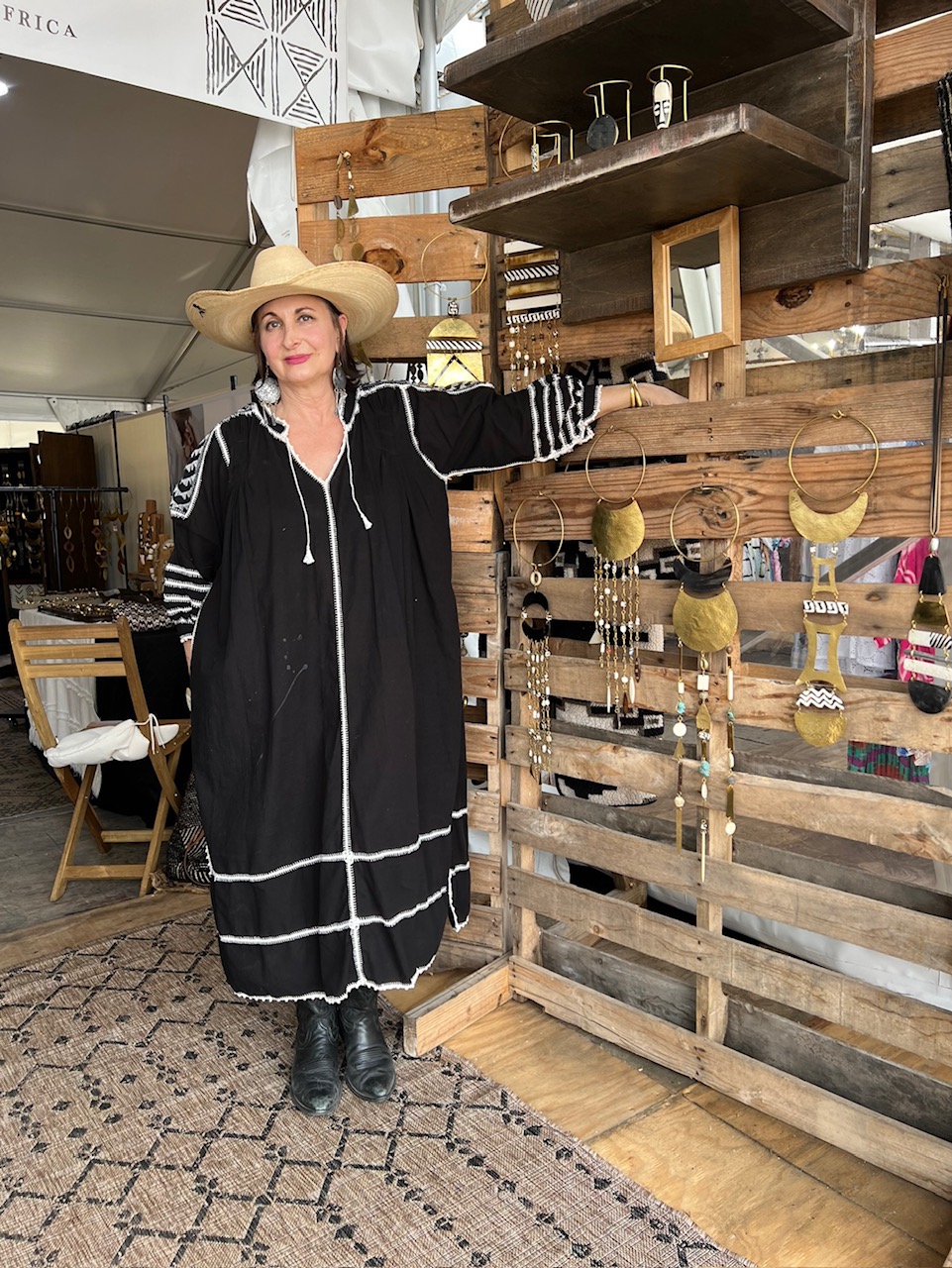 # Wooden Pallet Display Shelving Unit

This rustic wooden shelving unit is constructed from reclaimed or weathered wood planks arranged in a pallet-style configuration, featuring multiple open shelves and display sections. The shelving dates to the contemporary handmade/artisan era and showcases a natural honey and dark brown wood finish with visible grain and patina. Notable features include wire ring hangers for displaying jewelry and accessories, built-in compartments with mirrors, and functional display hooks for scarves and decorative items, making it ideal for retail or boutique jewelry and accessory presentation.