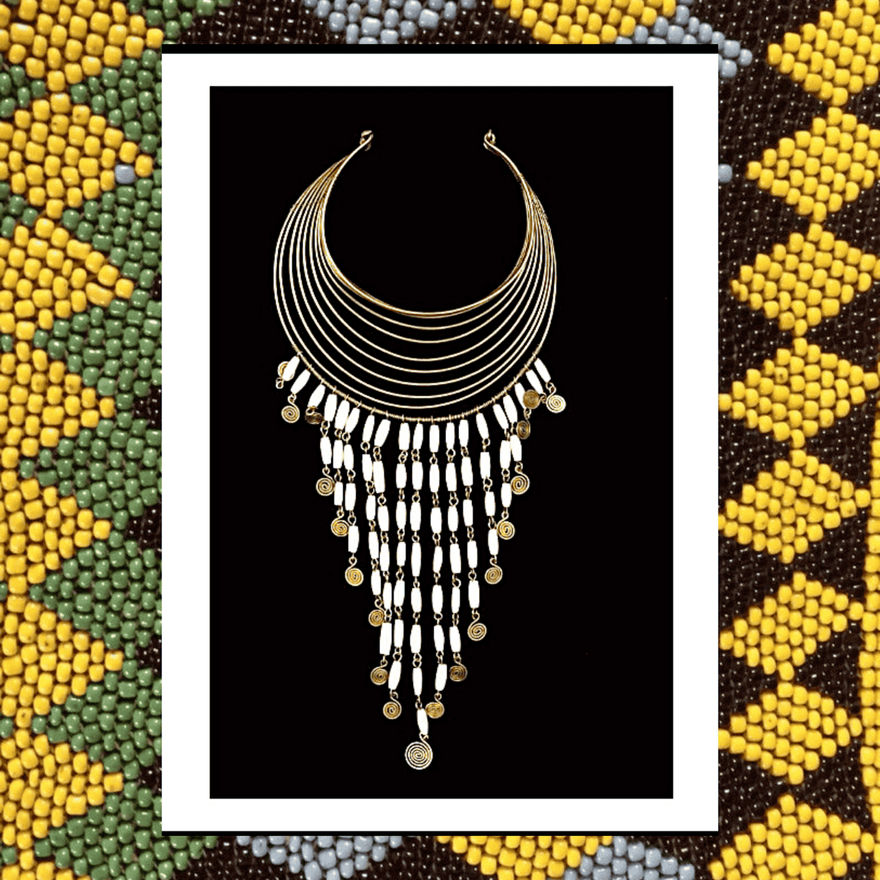 # Ornate Crescent Necklace Artwork with Beaded Border Frame

This is a framed illustration or print depicting an elaborate crescent-shaped collar necklace rendered in gold and white against a black background, featuring multiple strands of curved metal wires adorned with dangling white cylindrical beads and circular gold coins or medallions. The artwork appears to be inspired by African or ethnographic jewelry design, executed in a minimalist line-art style with metallic accents, likely from the 1970s-1990s era. The print is matted in white and bordered by a striking beaded frame featuring geometric patterns in yellow, green, brown, and white beads arranged in a traditional African textile-inspired design.