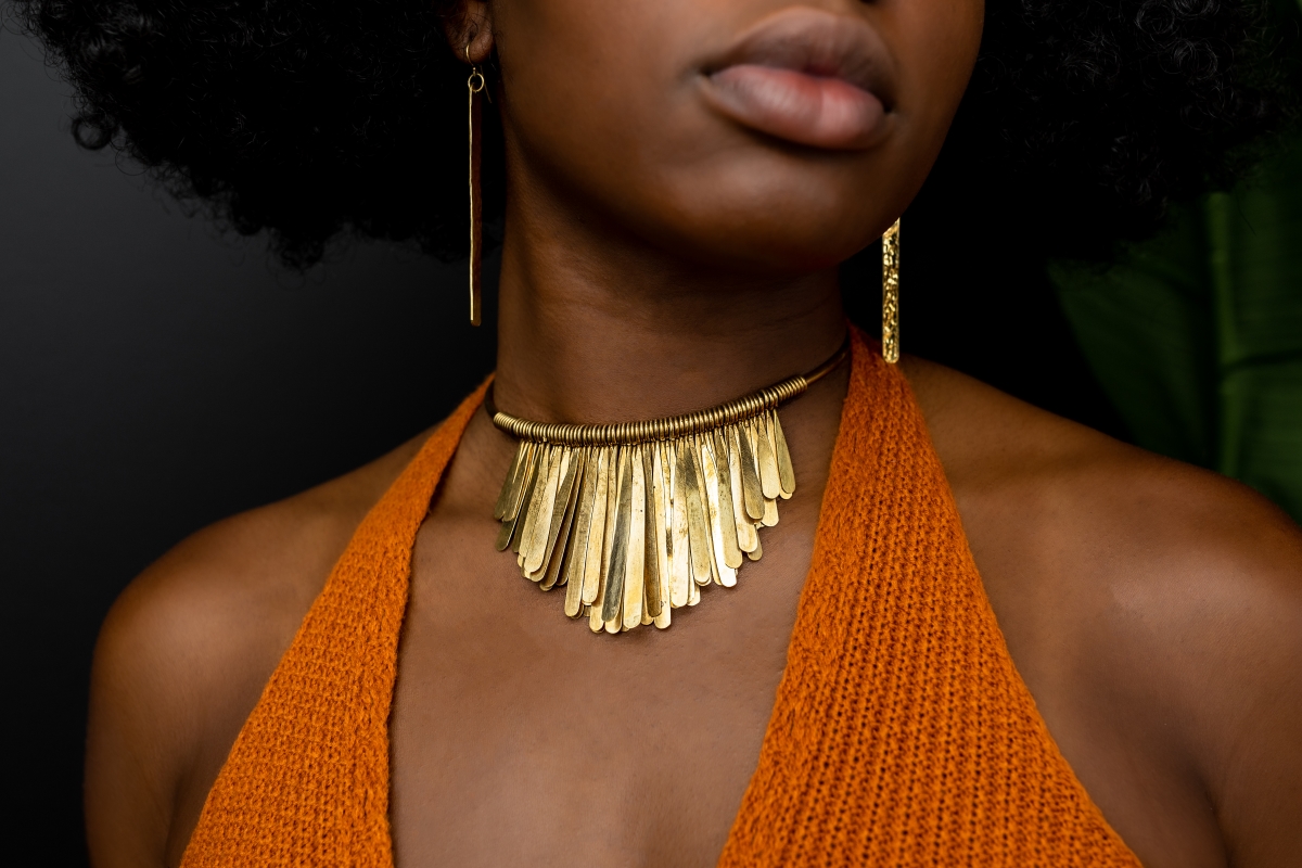 # Gold Statement Choker Necklace with Fringe Pendant

This bold statement choker features a polished gold-tone metal construction with a distinctive fan or shell-shaped fringe design composed of graduated rectangular plates hanging from a coiled serpentine chain. The piece exemplifies 1970s-1980s maximalist jewelry design, characterized by its geometric Art Deco-inspired aesthetic and substantial presence. The necklace is crafted from brass or gold-plated metal alloys typical of vintage costume jewelry from this era.