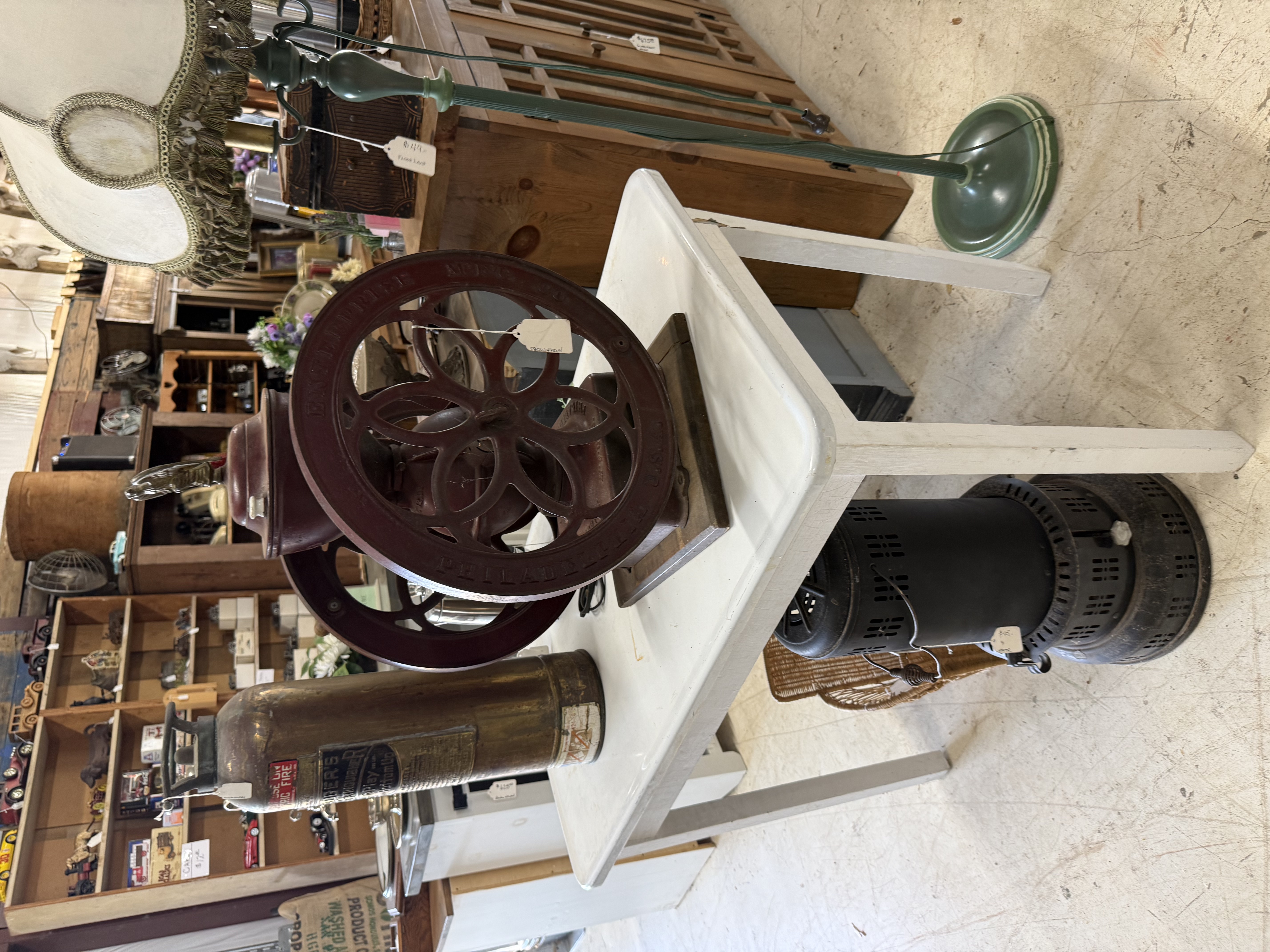 Antique coffee grinder and industrial wheel display