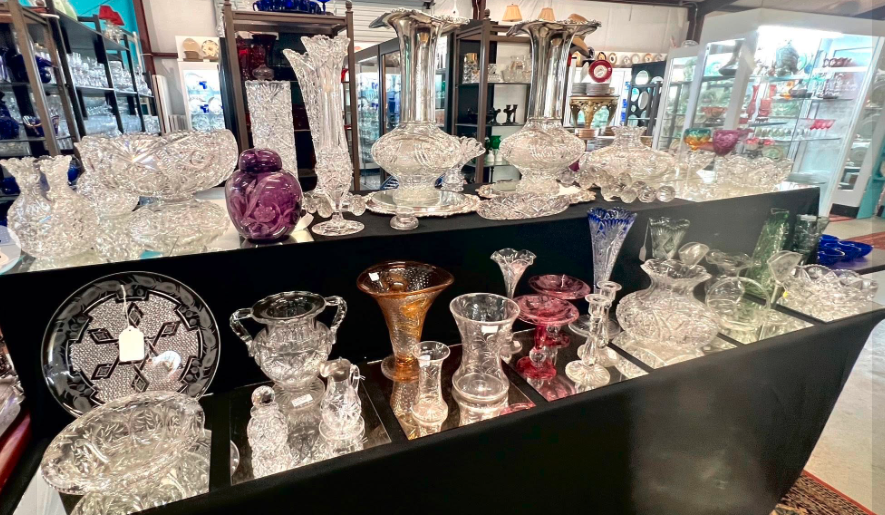 Fine decorative china plates — hand-painted floral with gilt borders on ornate gold table